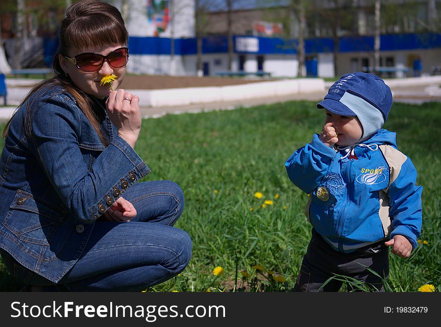 Photo of the Mother and son through dandelions