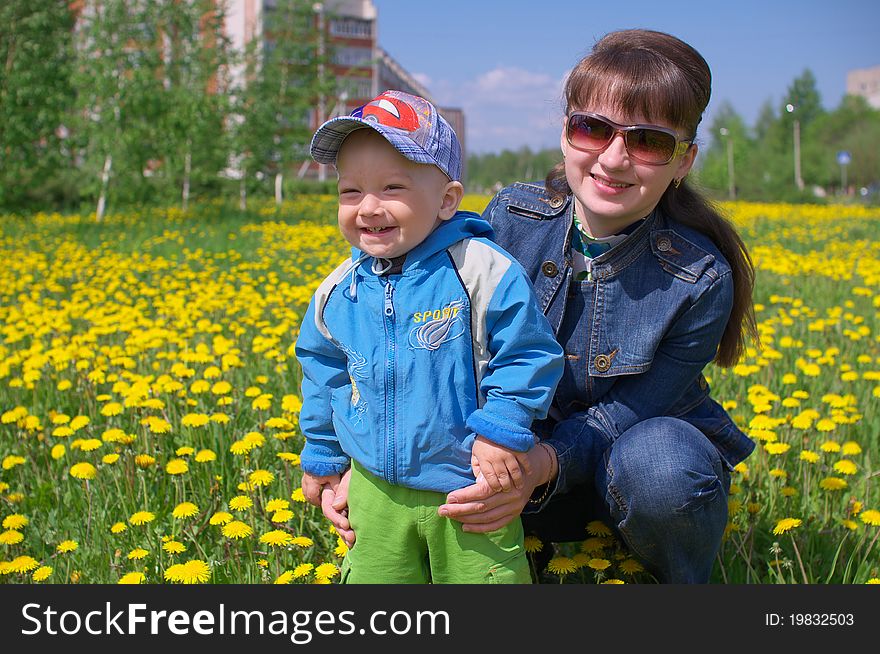 Photo of the Mother and son through dandelions