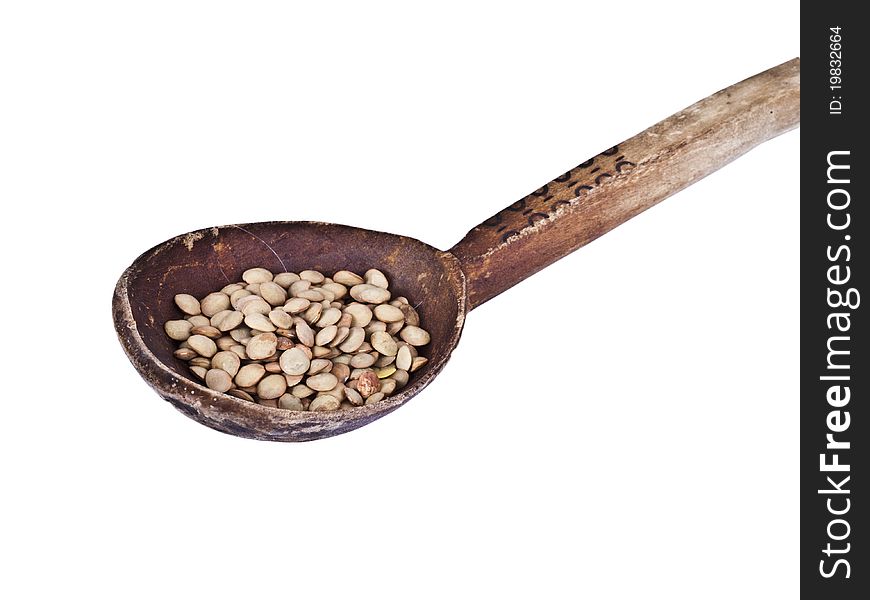 Wood spoon with lentils isolated on white