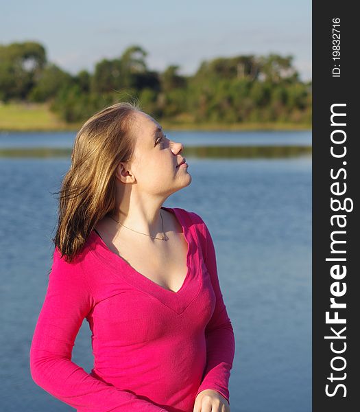 Smiling beautiful girl at the park lake. Smiling beautiful girl at the park lake