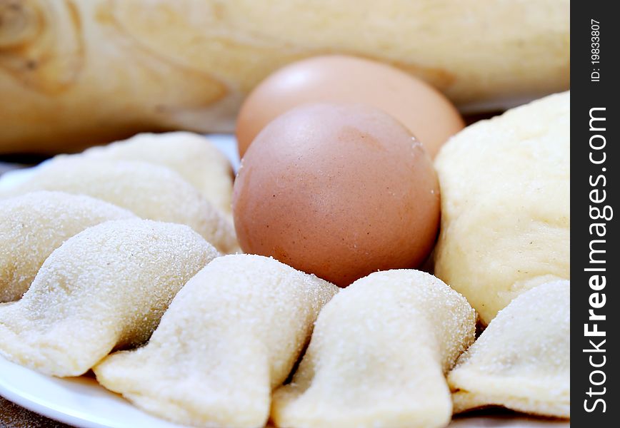 Preparing of pelmeni - meatballs in dough with eggs. Preparing of pelmeni - meatballs in dough with eggs