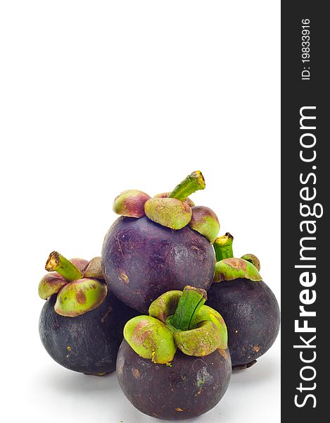Mangosteen is a tropical fruit in white background