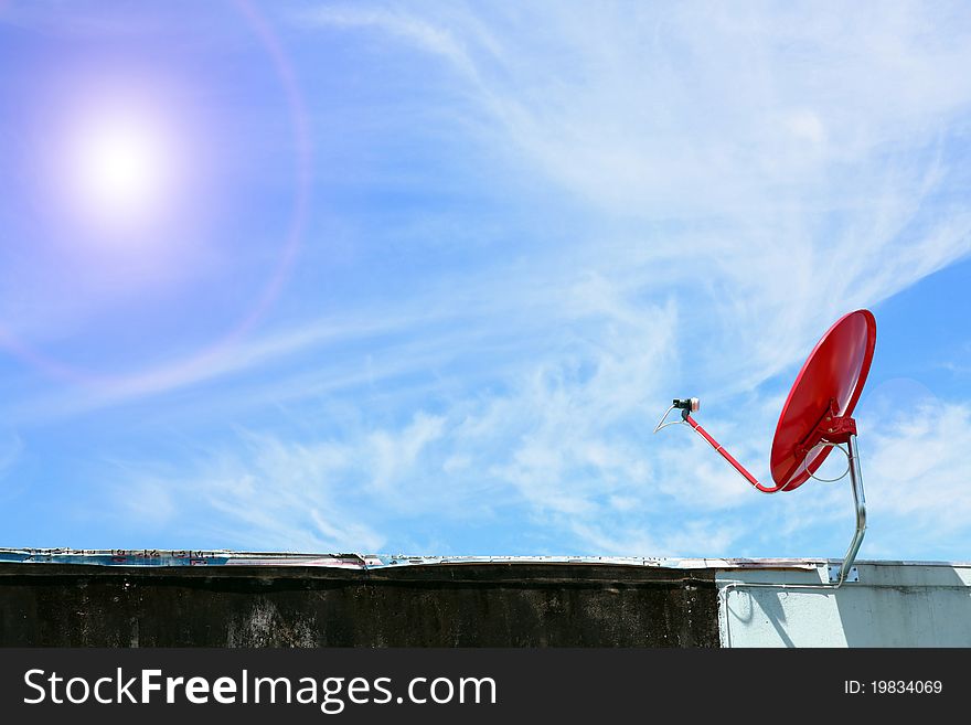 Isolated red satellite on sunny blue sky. Isolated red satellite on sunny blue sky