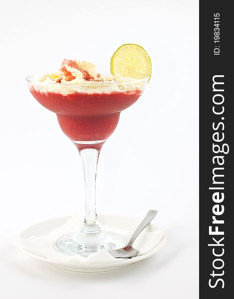 Dessert ice-cream with a lemon and liquor in a vase on a long leg on a white background. Dessert ice-cream with a lemon and liquor in a vase on a long leg on a white background