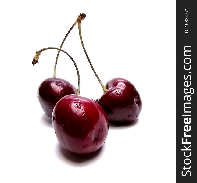 Three cherries on a white background. Three cherries on a white background