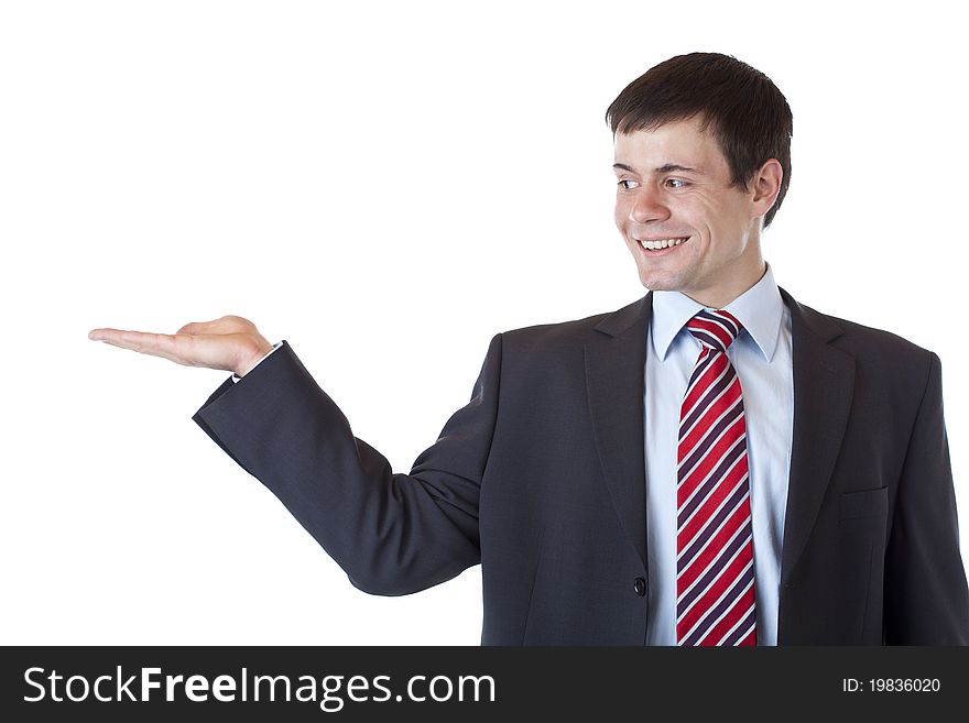 Young businessman looks at ad text in his palm and smiles. Isolated on white background. Young businessman looks at ad text in his palm and smiles. Isolated on white background.