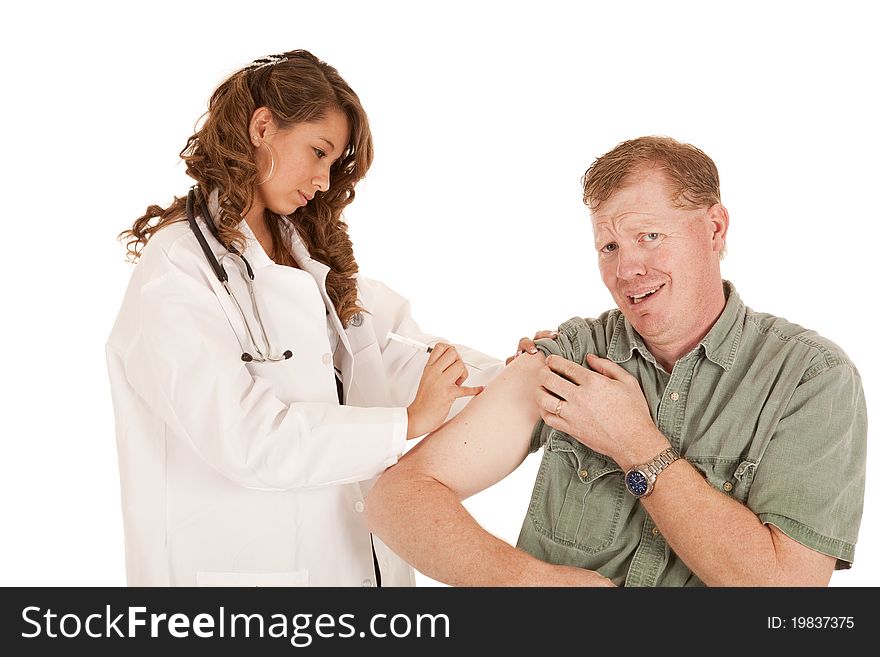 A doctor giving her paitent a shot in the arm, the patient is about to cry. A doctor giving her paitent a shot in the arm, the patient is about to cry.