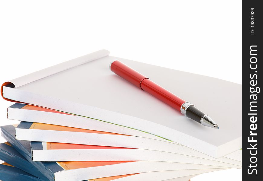 Red pen lays on notebook stack takes notes. Red pen lays on notebook stack takes notes