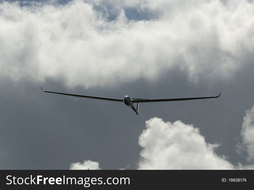 Glider flight with moody backdrop of clouds. Glider flight with moody backdrop of clouds.