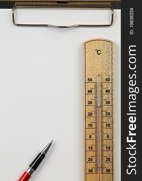 Temperature meter , pen , be locate on clip board , and colored white paper. Temperature meter , pen , be locate on clip board , and colored white paper