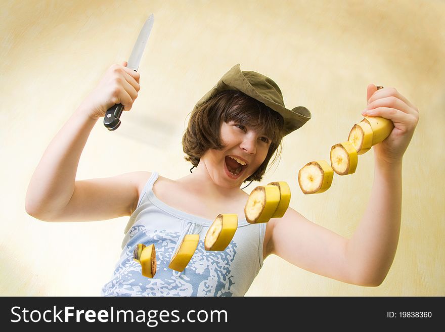 The girl with a knife cut a banana in the air. The girl with a knife cut a banana in the air.