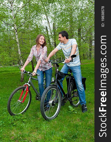 Happy young couple riding bicycles