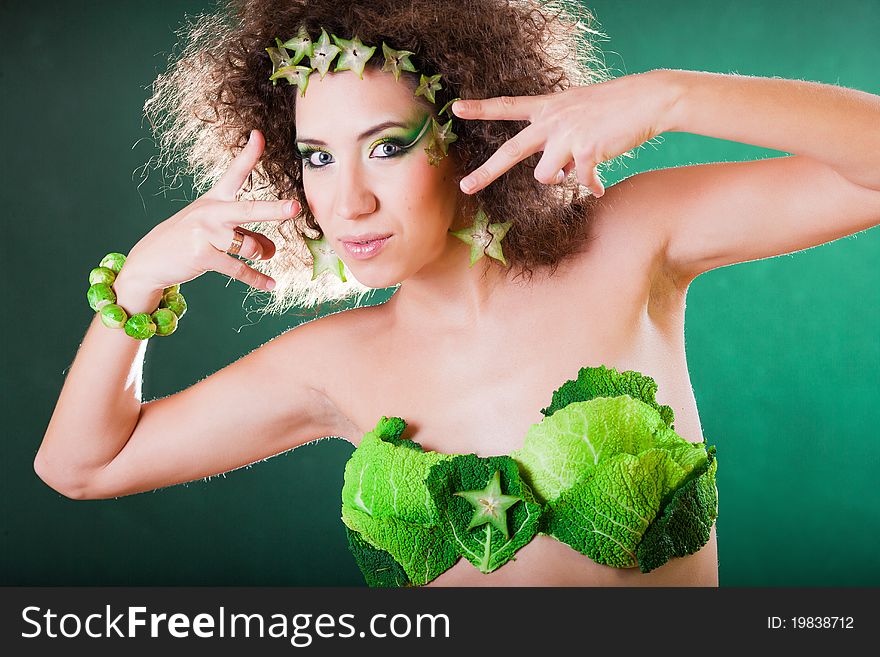 Beautiful pregnant young woman dressed in cabbage