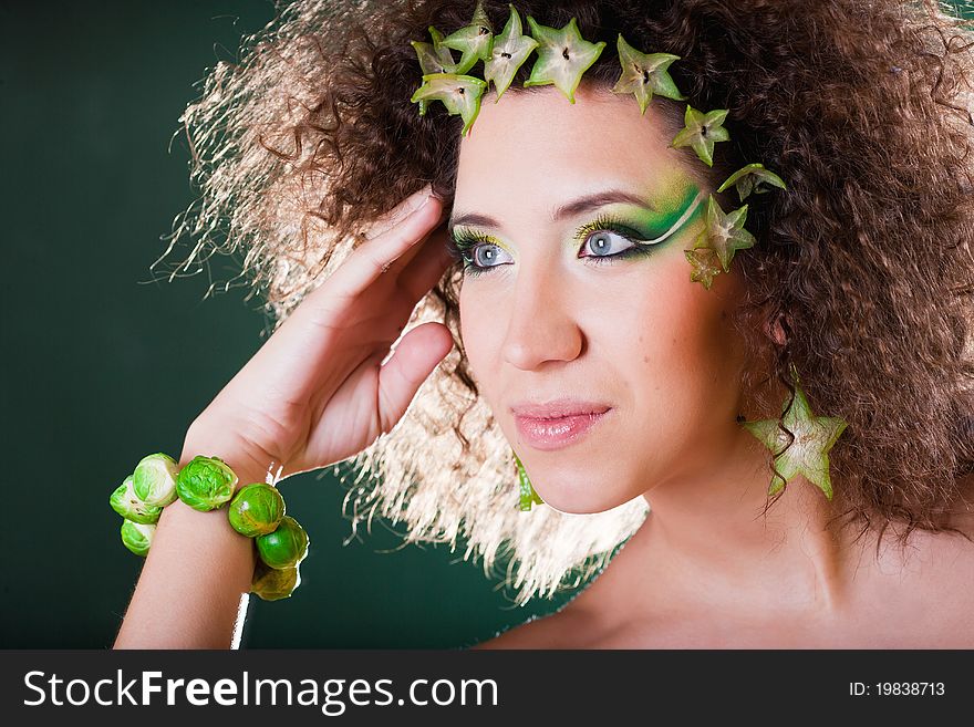 Beautiful pregnant young woman dressed in cabbage