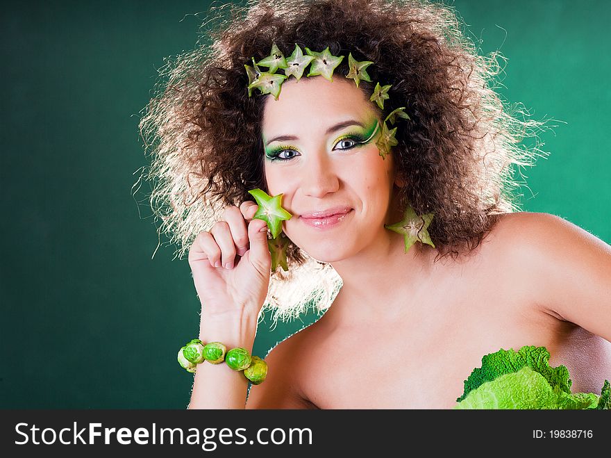 Beautiful pregnant young woman dressed in cabbage