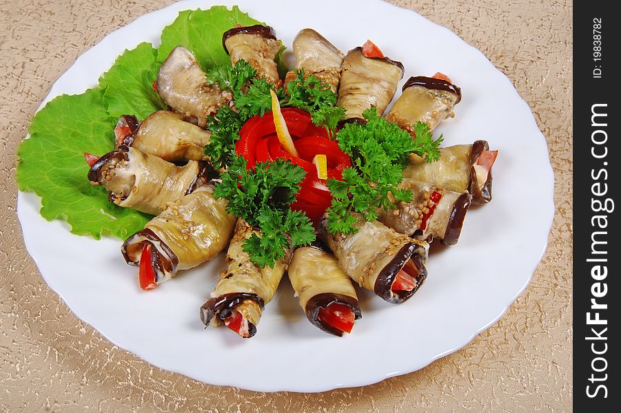 Egg-plant rolls on white plate. Egg-plant rolls on white plate