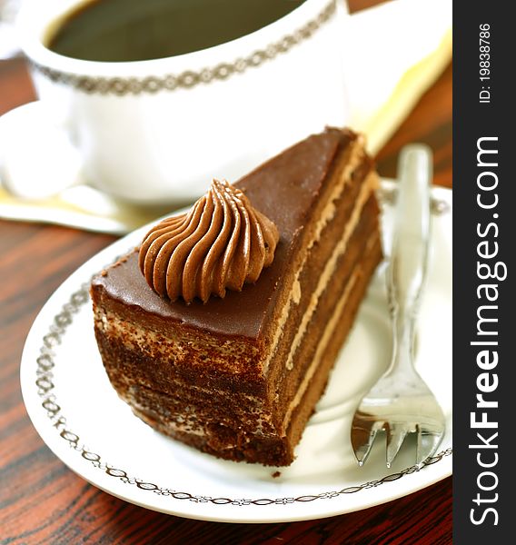 Chocolate cake on plate and cup