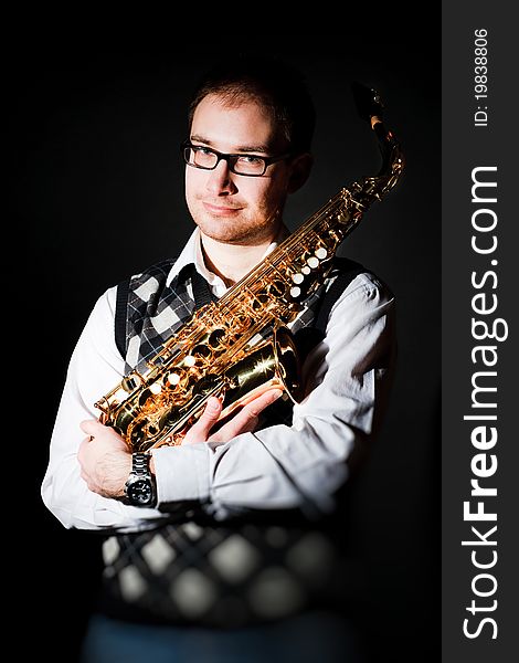 Portrait of a man with a saxophone/playing on sax