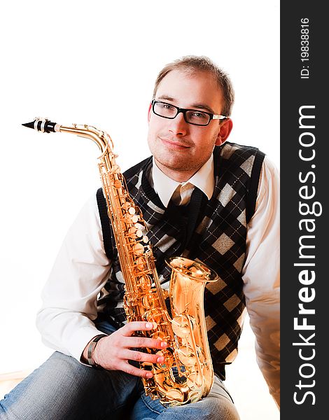 Portrait of a man with a saxophone/playing on sax isolated on white