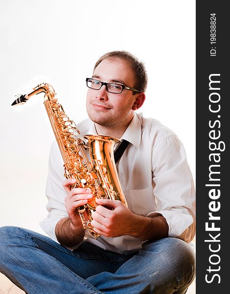 Portrait of a man with a saxophone/playing on sax isolated on white