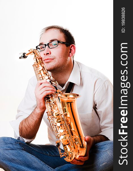 Portrait of a man with a saxophone/playing on sax isolated on white