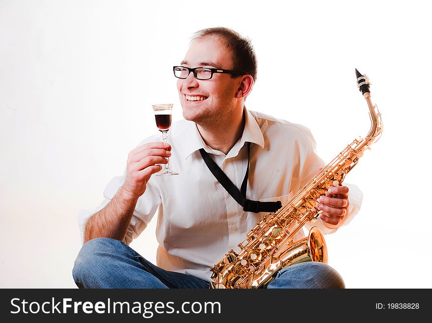 Portrait of a man with a saxophone/playing on sax isolated on white