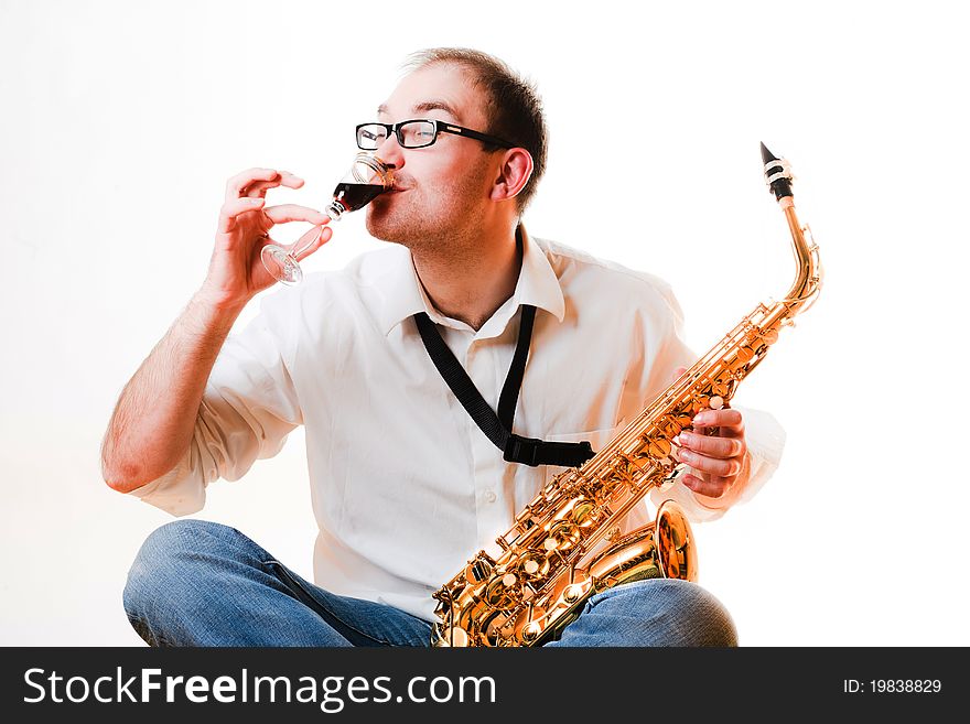 Portrait of a man with a saxophone/playing on sax isolated on white