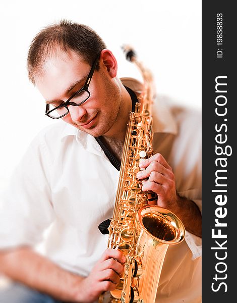 Portrait of a man with a saxophone/playing on sax isolated on white