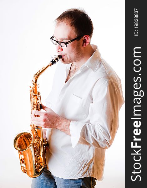 Portrait of a man with a saxophone/playing on sax isolated on white