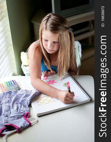 Young Girl Drawing Clothing By Window