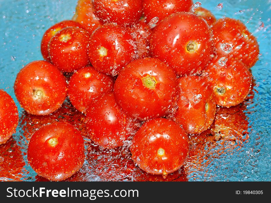 Fresh tomatoes in water and splashes