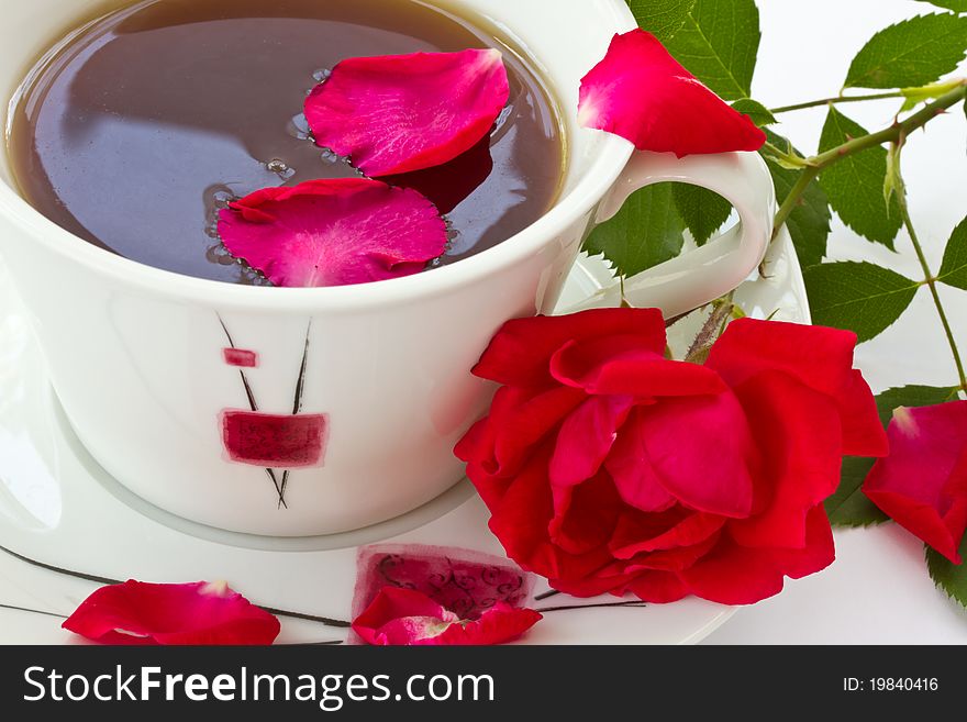 Rose tea, and red rose with petals