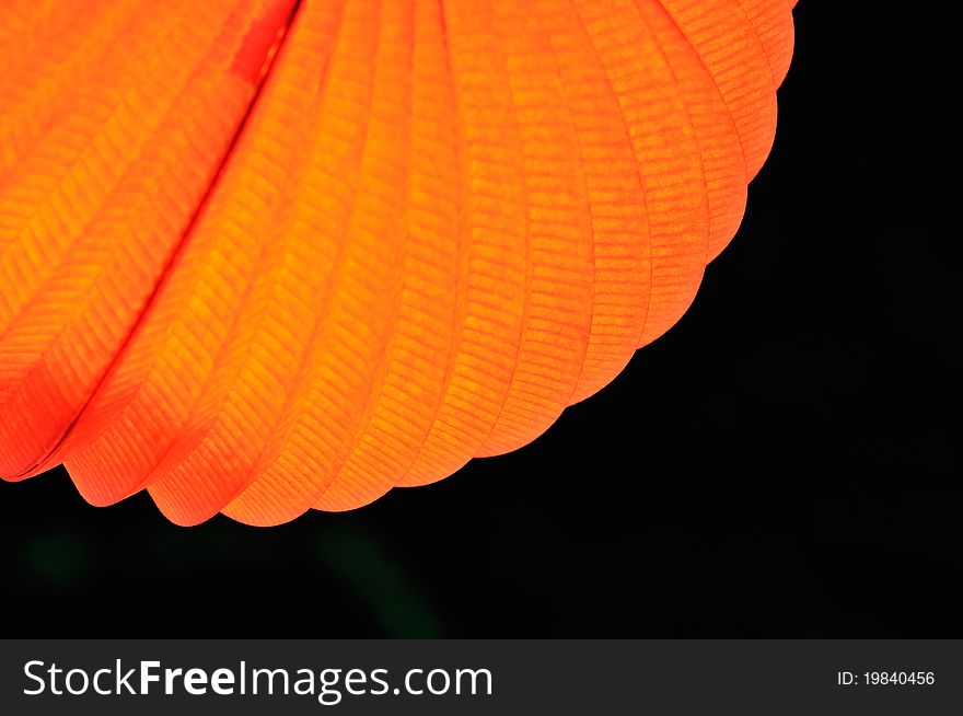 Chinese paper lantern in illuminating orange light at night