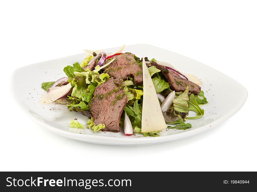 Green salad with meat and cheese on white palte isolated on white background
