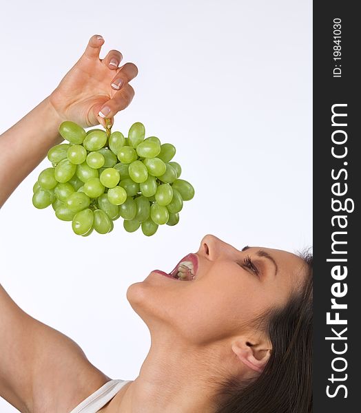 Young woman eating fresh grapes. Young woman eating fresh grapes