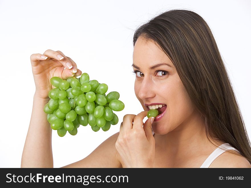 Young woman eating fresh grapes - studio. Young woman eating fresh grapes - studio