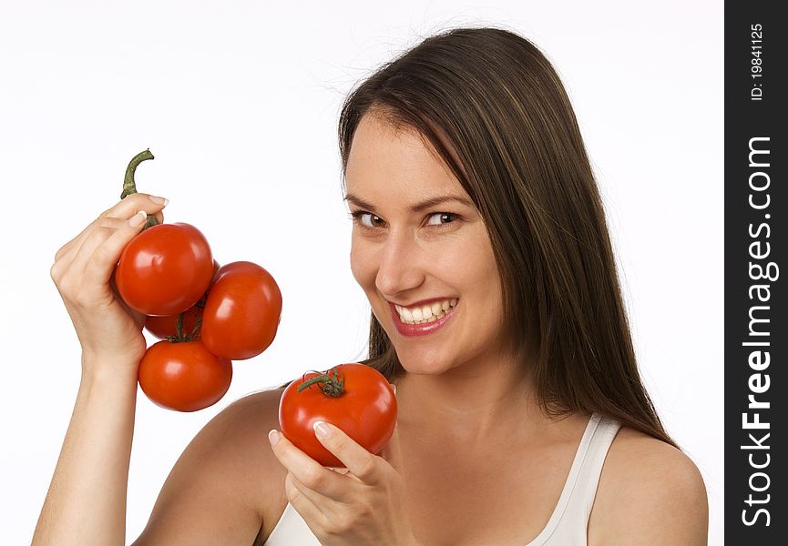 Young woman holding fresh tomatoes and smiling. Young woman holding fresh tomatoes and smiling