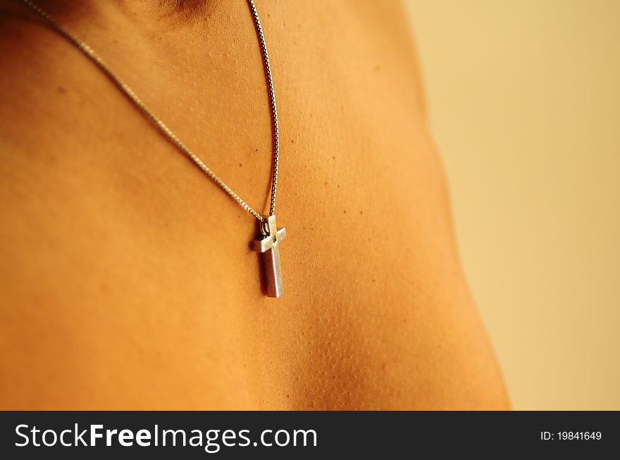 A black, african-american, latina, ethnic, woman proudly wears her silver cross necklace. A black, african-american, latina, ethnic, woman proudly wears her silver cross necklace.