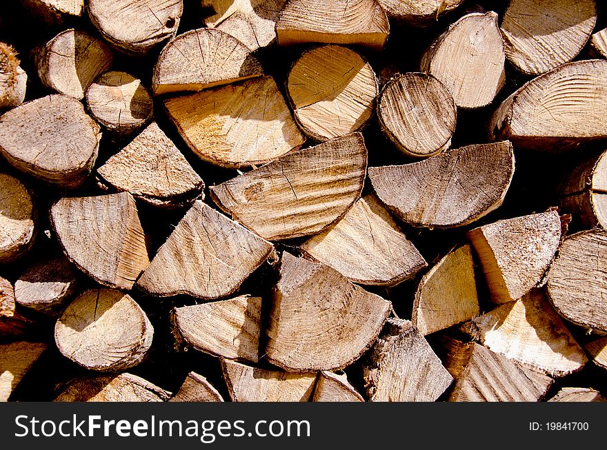 Fragment of choppen firewood. Wooden texture background .