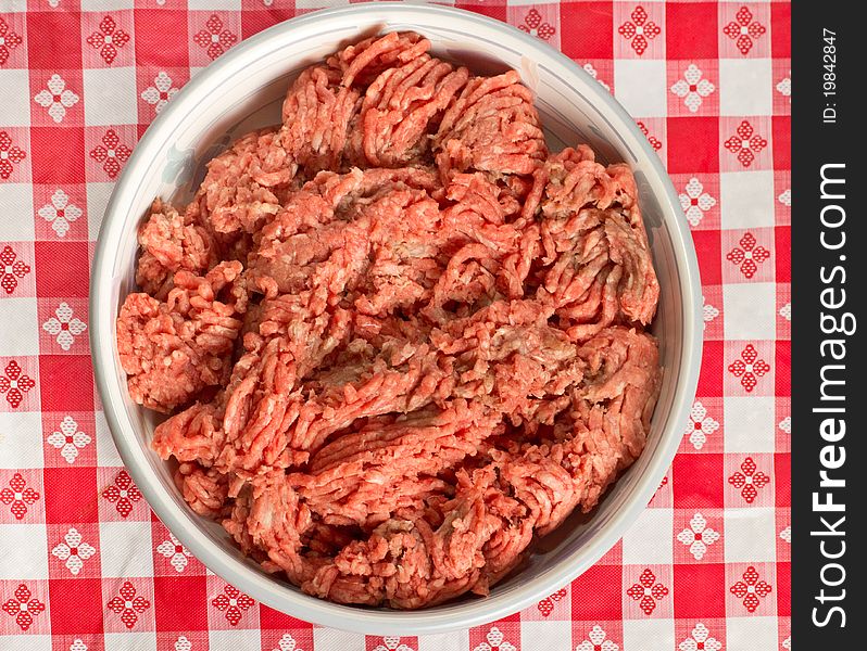 A bowl of uncooked ground beef in preparation of a meal