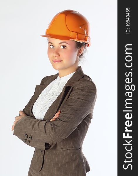 The young and beautiful girl in a business suit and a building helmet. The young and beautiful girl in a business suit and a building helmet