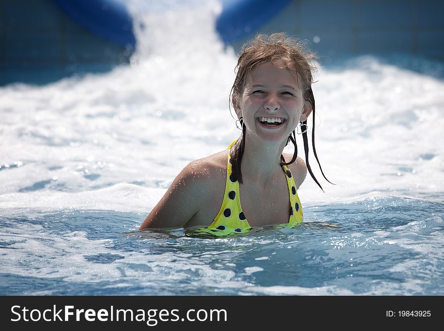 Happy girl with a big smile in a blue pool. Happy girl with a big smile in a blue pool