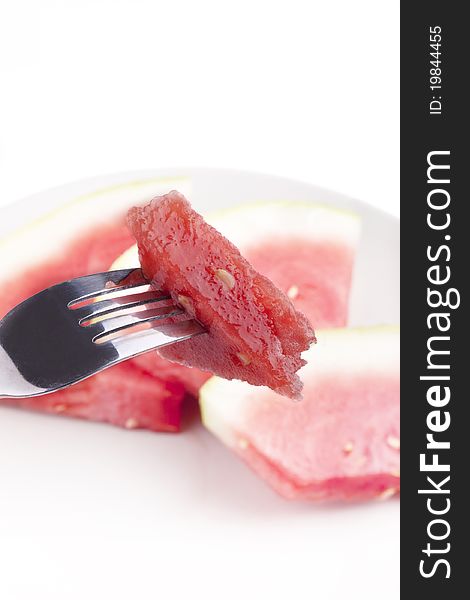 Studio-shot of a fork with a piece of watermelon, isolated on white.