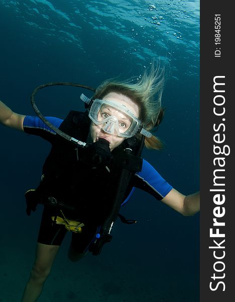 Blond female scuba diver in ocean