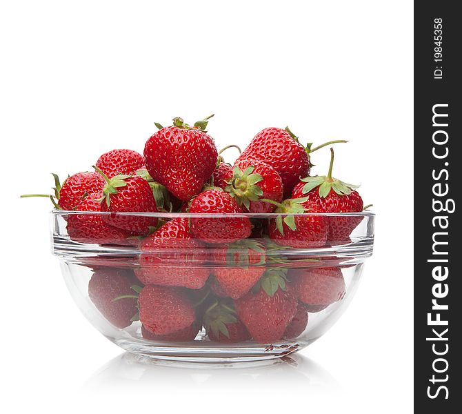 Fresh strawberries in a glass dish on white background. Fresh strawberries in a glass dish on white background.