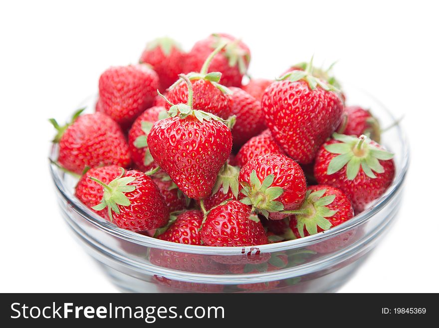 Fresh strawberries in a glass dish on white background. Fresh strawberries in a glass dish on white background.