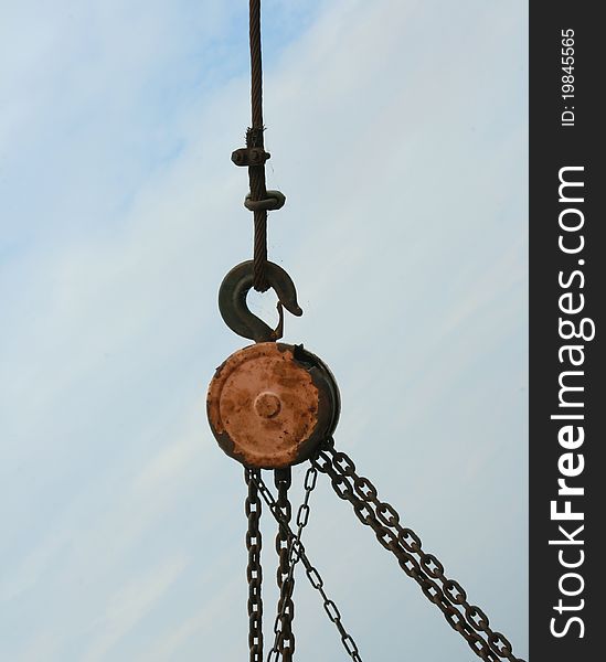 Rusty chains hanging on blue sky