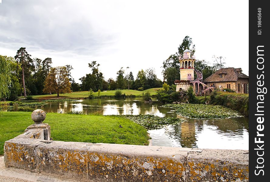 The Marlborough Tower and pond in Marie-Antoinette's estate. Versailles Chateau. France .