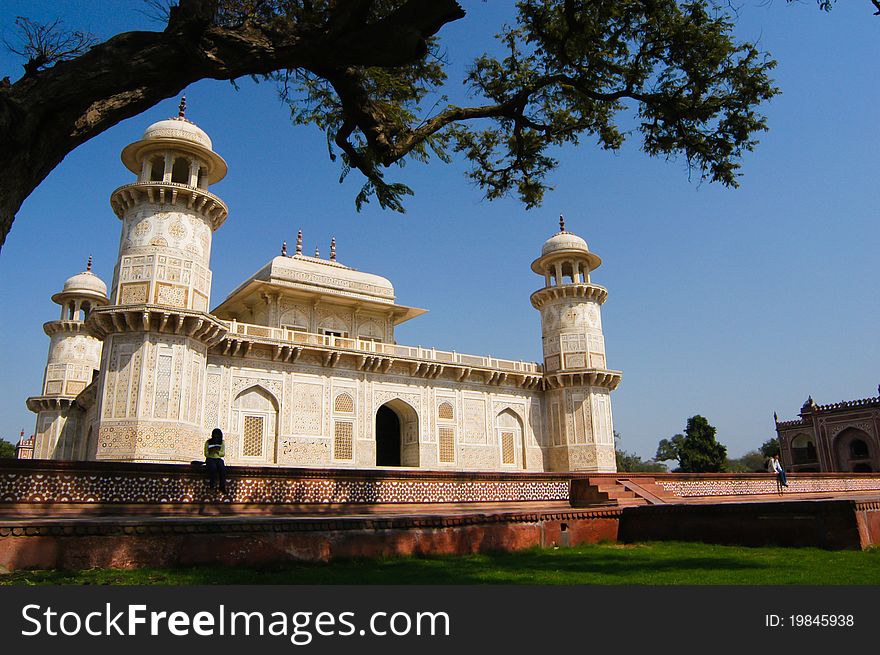 Visitors sit in front of Itimad-ud-Daula's Tomb or better known as Baby Taj in Agra, India. Visitors sit in front of Itimad-ud-Daula's Tomb or better known as Baby Taj in Agra, India.