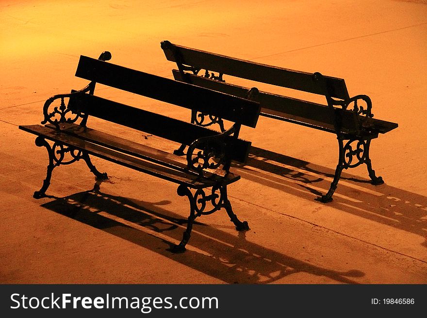 Benches under the glowing light of street lamp. Benches under the glowing light of street lamp